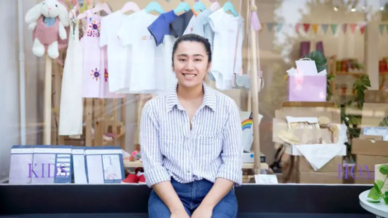 Asian woman in front of kids store